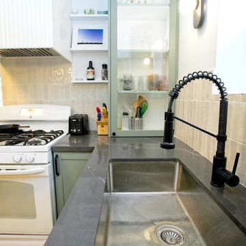 Stainless Sink and Black Faucet Beside Glass Display Storage | East York