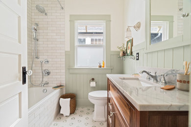 Inspiration for a timeless white tile mosaic tile floor, multicolored floor, single-sink and wainscoting bathroom remodel in Portland with recessed-panel cabinets, medium tone wood cabinets, white walls, an undermount sink and gray countertops