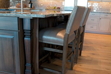 Eat-in kitchen - transitional eat-in kitchen idea in Boston with a farmhouse sink, quartz countertops, metallic backsplash, glass tile backsplash and stainless steel appliances