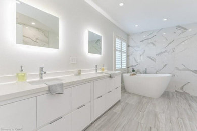 Mid-sized minimalist master white tile and porcelain tile porcelain tile, gray floor and double-sink bathroom photo in Other with flat-panel cabinets, white cabinets, a two-piece toilet, gray walls, an undermount sink, quartzite countertops, a hinged shower door, white countertops and a freestanding vanity