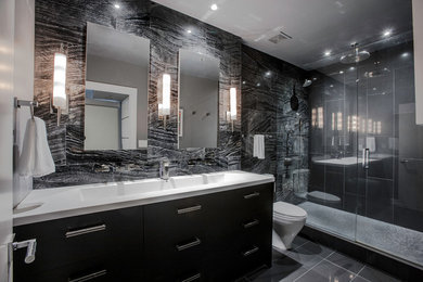 Example of a minimalist bathroom design in Atlanta with a wall-mount toilet and black walls