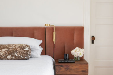 Bedroom - large transitional master medium tone wood floor bedroom idea in Baltimore with white walls