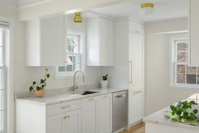 Eat-in kitchen - small transitional galley light wood floor eat-in kitchen idea in Minneapolis with flat-panel cabinets, white cabinets, quartzite countertops, stainless steel appliances and white countertops