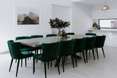 Photo of a contemporary kitchen/dining combo in Melbourne with white walls and porcelain floors.