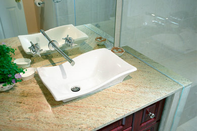 Example of a small 3/4 beige tile porcelain tile corner shower design in Other with dark wood cabinets and beige walls