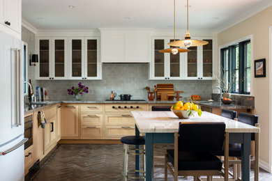 Example of a mid-sized transitional u-shaped ceramic tile and black floor eat-in kitchen design in Los Angeles with a double-bowl sink, beaded inset cabinets, light wood cabinets, quartzite countertops, blue backsplash, subway tile backsplash, paneled appliances, no island and gray countertops
