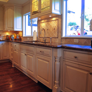 Mid-sized traditional kitchen pantry inspiration - Mid-sized elegant u-shaped medium tone wood floor kitchen pantry photo in Santa Barbara with a double-bowl sink, beaded inset cabinets, white cabinets, granite countertops, multicolored backsplash, paneled appliances and an island