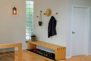 Vestibule with custom bench and wooden hooks