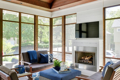 Inspiration for a mid-sized coastal brick side porch remodel in Phoenix with a fire pit and a roof extension