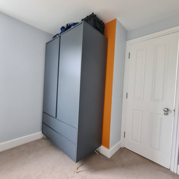Loft bedroom with orange wall future in Wimbledon SW19