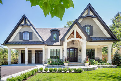 Design ideas for a traditional two-storey grey exterior in Toronto with a gable roof.