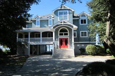 Large coastal blue two-story mixed siding exterior home idea in Other