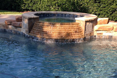 Island style pool photo in Houston