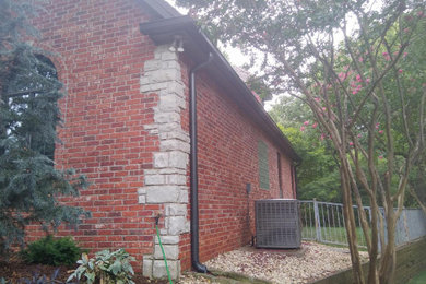Inspiration for a large modern two-story brick house exterior remodel in Oklahoma City with a hip roof and a shingle roof