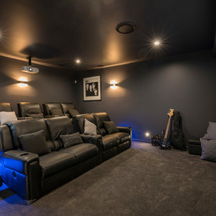 Example of a trendy enclosed carpeted and gray floor home theater design in Brisbane with gray walls