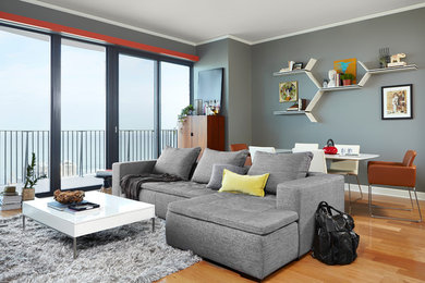 Inspiration for a small contemporary open concept light wood floor living room remodel in Chicago with gray walls and no fireplace