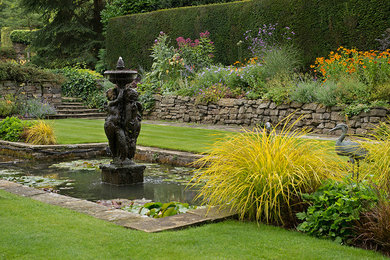 Design ideas for a classic formal partial sun raised pond for summer in Other.