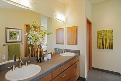 Inspiration for a mid-sized contemporary master slate floor bathroom remodel in Seattle with a drop-in sink, flat-panel cabinets, medium tone wood cabinets and white walls
