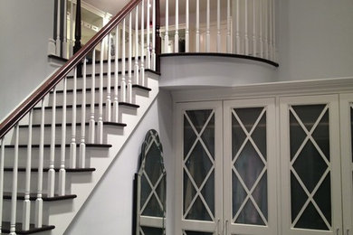 Mid-sized elegant wooden straight wood railing staircase photo in New York with painted risers