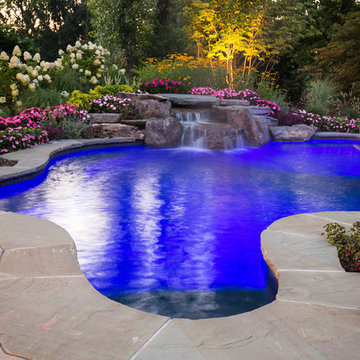 custom pool lighting and an amazing natural stone waterfall