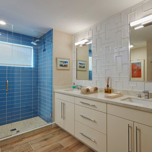 Coastal 3/4 blue tile and glass tile beige floor alcove shower photo in Miami with flat-panel cabinets, beige cabinets, an undermount sink and a hinged shower door