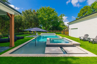 Pool - large modern backyard stone and rectangular pool idea in Houston