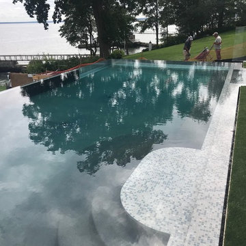 vanishing edge glass wall pool + raised perimeter overflow spa