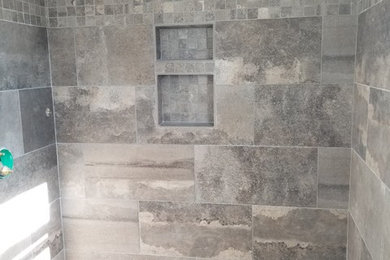 Transitional master bathroom in Boston with an alcove shower and gray tile.