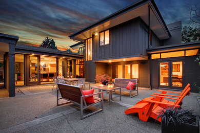 Patio - mid-sized mid-century modern courtyard concrete patio idea in Seattle with no cover