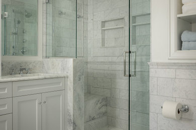 Inspiration for a mid-sized transitional master gray tile and marble tile marble floor, gray floor, double-sink and wainscoting bathroom remodel in Kansas City with shaker cabinets, white cabinets, a two-piece toilet, white walls, an undermount sink, marble countertops, a hinged shower door, gray countertops and a built-in vanity