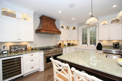 Inspiration for a large transitional l-shaped dark wood floor open concept kitchen remodel in Other with a double-bowl sink, shaker cabinets, white cabinets, stainless steel appliances, two islands and marble countertops