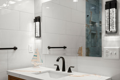 Example of a large trendy master white tile and ceramic tile ceramic tile, white floor and single-sink bathroom design in Atlanta with a freestanding vanity, raised-panel cabinets, brown cabinets, a two-piece toilet, white walls, an undermount sink, quartz countertops, a hinged shower door and white countertops