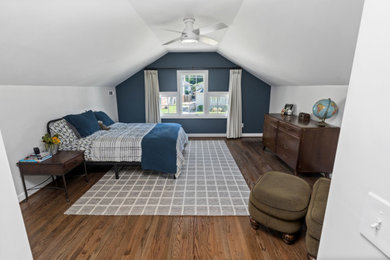 Mid-sized minimalist medium tone wood floor and vaulted ceiling bedroom photo in Atlanta