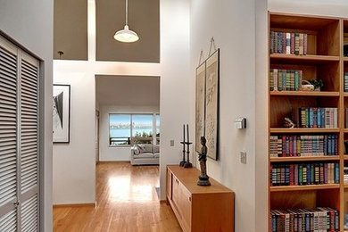 Inspiration for a mid-sized timeless medium tone wood floor hallway remodel in Seattle with beige walls