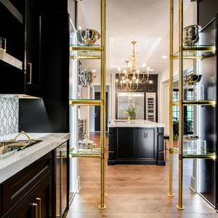 Mid-sized transitional kitchen pantry appliance - Kitchen pantry - mid-sized transitional galley medium tone wood floor kitchen pantry idea in Richmond with a double-bowl sink, shaker cabinets, black cabinets, gray backsplash, stainless steel appliances and an island