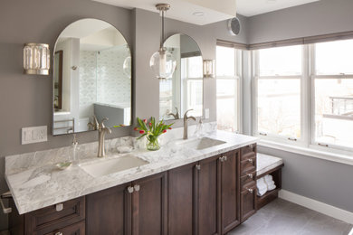 Elegant master white tile gray floor bathroom photo in Seattle with gray walls, marble countertops, white countertops, dark wood cabinets and a built-in vanity