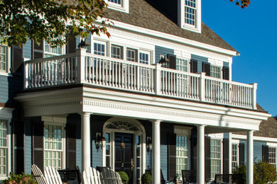 Inspiration for a timeless blue two-story wood and clapboard exterior home remodel in Boston with a shingle roof