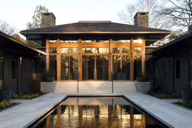 Large contemporary black one-story mixed siding house exterior idea in Atlanta with a hip roof and a shingle roof