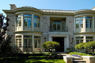 Inspiration for a large eclectic beige two-story brick exterior home remodel in Toronto