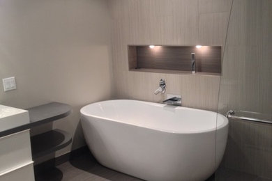 Inspiration for a mid-sized contemporary master multicolored tile and porcelain tile porcelain tile and beige floor bathroom remodel in Other with flat-panel cabinets, white cabinets, beige walls, an integrated sink and solid surface countertops