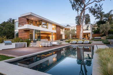 This is an example of a contemporary backyard rectangular pool in Los Angeles with decking.