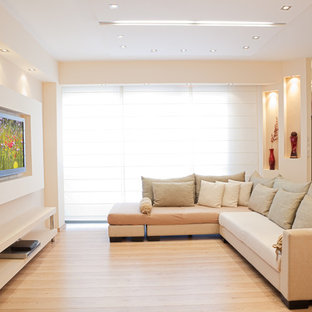 Photo of a medium sized modern open plan home cinema in Los Angeles with white walls, vinyl flooring and a wall mounted tv.