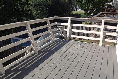 Example of a small arts and crafts backyard deck design in DC Metro with no cover