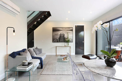 Design ideas for a small modern enclosed family room in Melbourne with white walls, ceramic floors and grey floor.