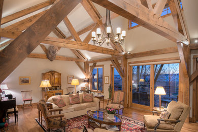 Large mountain style formal and open concept medium tone wood floor and brown floor living room photo in Denver with beige walls