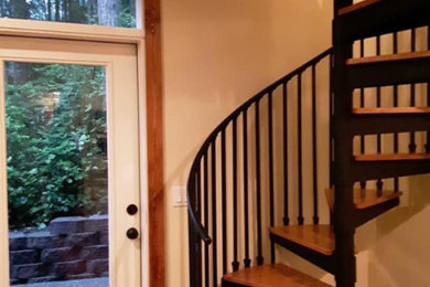 Staircase - mid-sized contemporary wooden curved metal railing staircase idea in Seattle