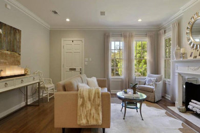 Example of a transitional medium tone wood floor living room design with white walls