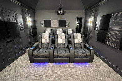 Inspiration for a mid-sized timeless enclosed carpeted and gray floor home theater remodel in Dallas with gray walls and a projector screen