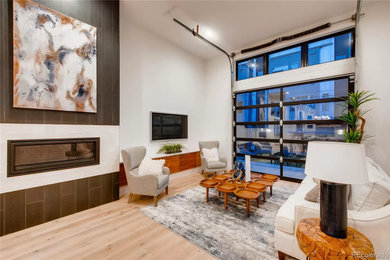 Inspiration for a large modern open concept living room remodel in Denver with a tile fireplace