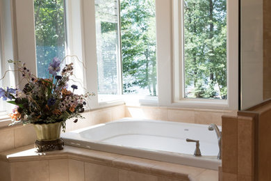 Example of a large classic master beige tile and travertine tile travertine floor and beige floor bathroom design in Milwaukee with white cabinets, beige walls and a hinged shower door